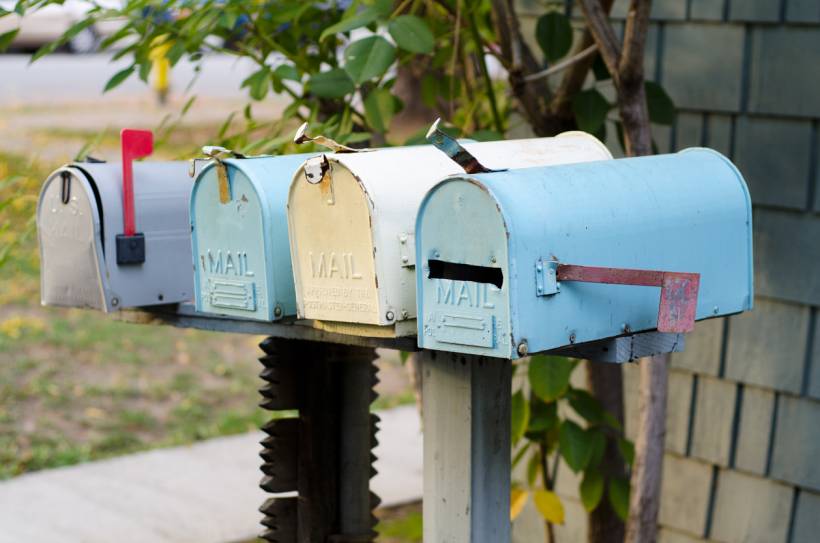 mailbox installation cost - Row of mailboxes positioned along a neighborhood street