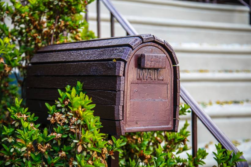mailbox installation cost - Brown mailbox with a rustic look placed in a residential outdoor area