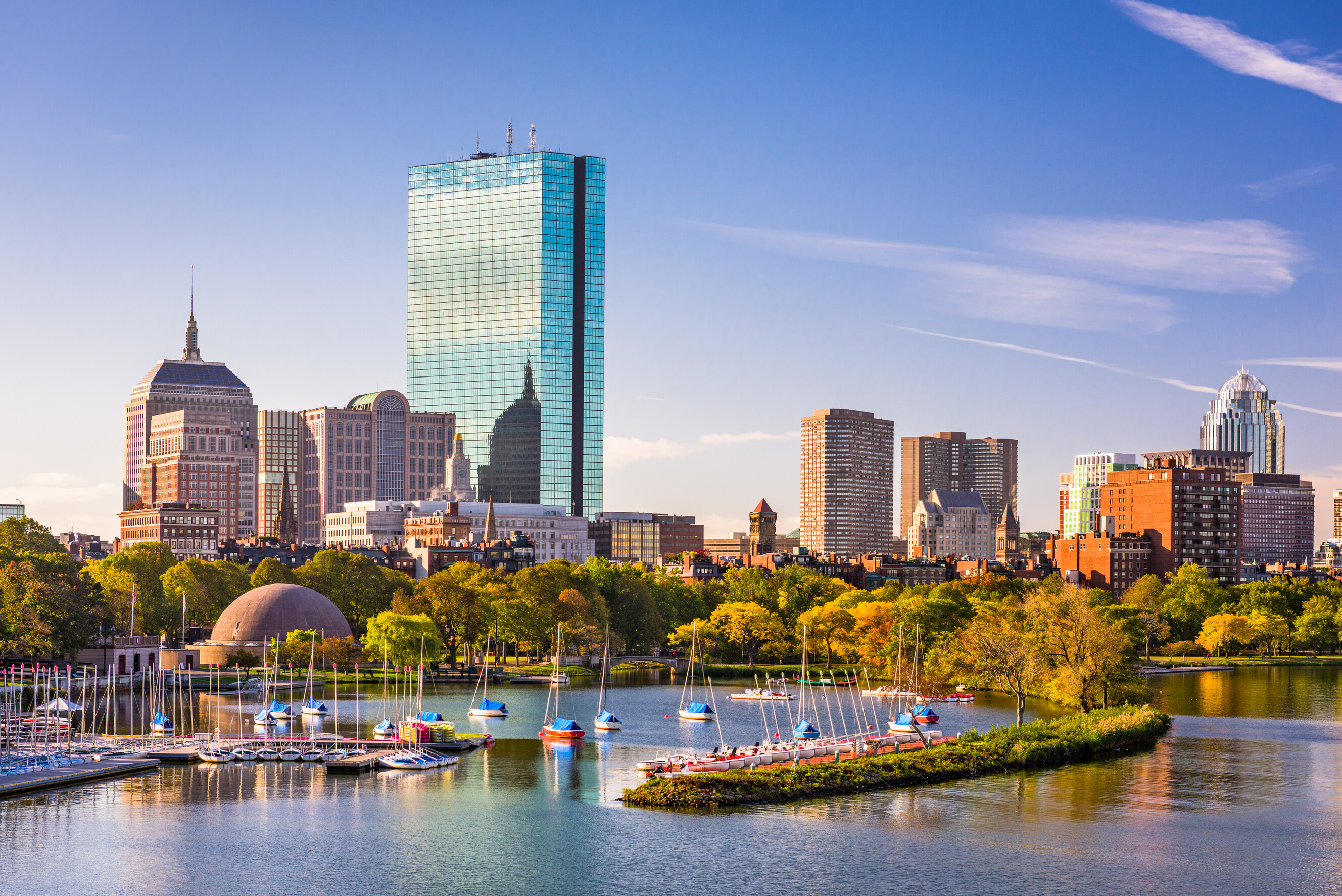 The sun setting over the iconic buildings and waterfront of the city of Boston.