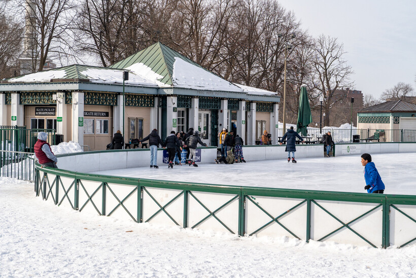 People of all ages enjoying outdoor ice skating at the Frog Pond in winter. - moving to Boston