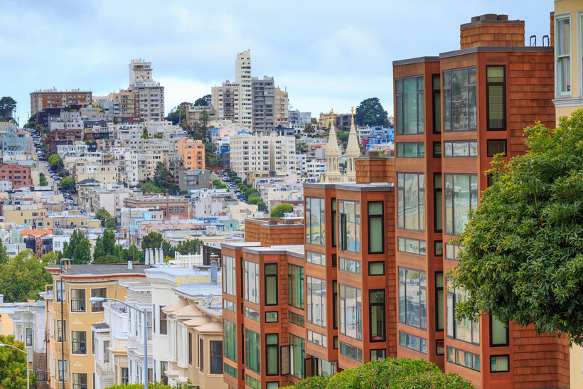 Rows of colorful houses on a sloping residential street in the city. - moving to San Francisco