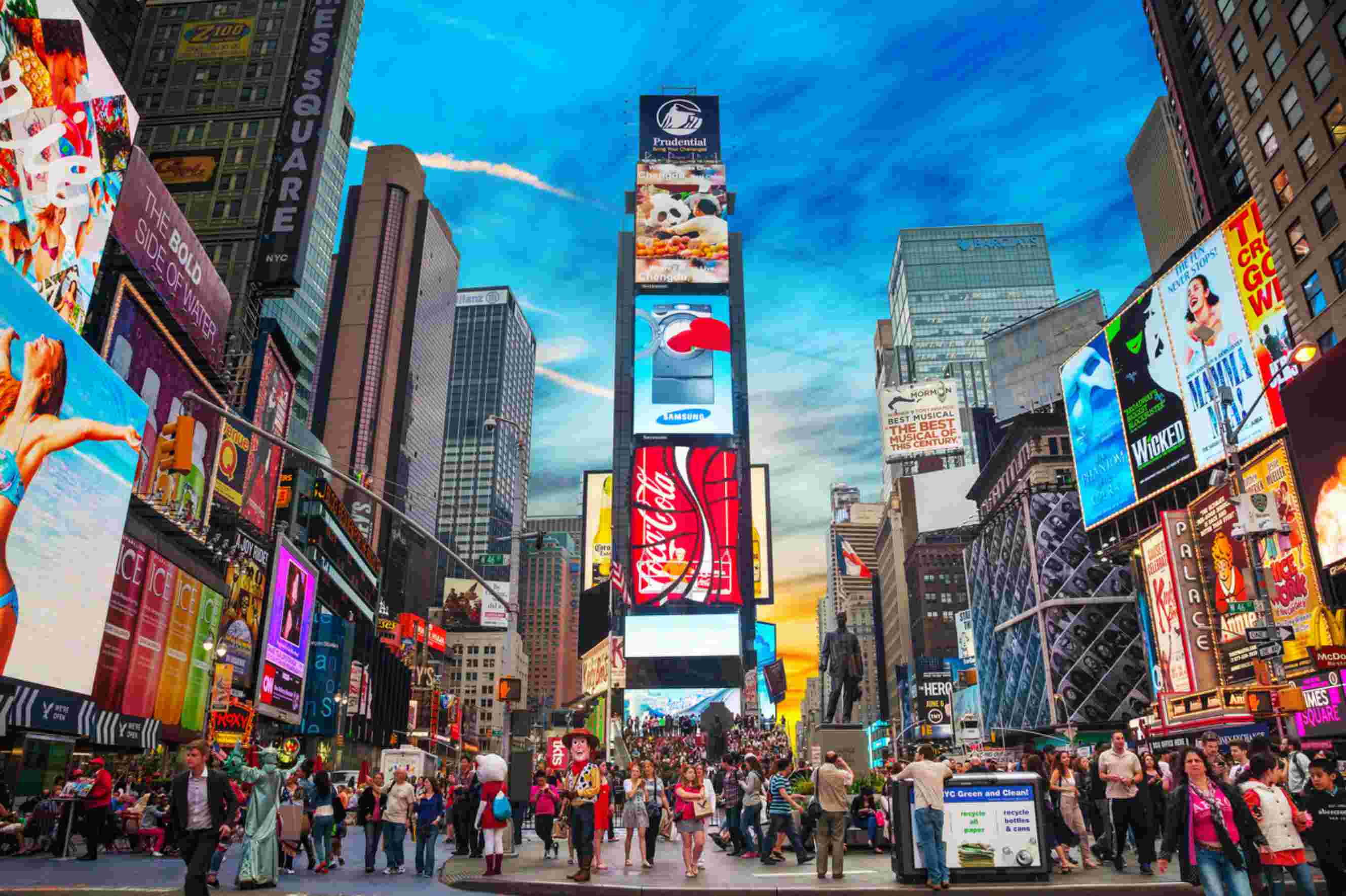 Times Square in New York City with crowds and illuminated billboards, a common destination for people moving from California to New York