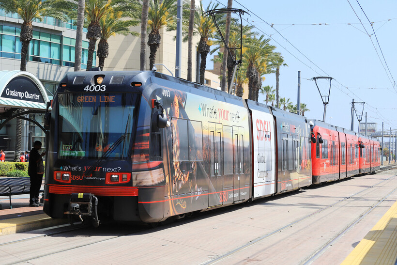 Commuters boarding the green line trolley at the Gaslamp Quarter station. - moving to San Diego