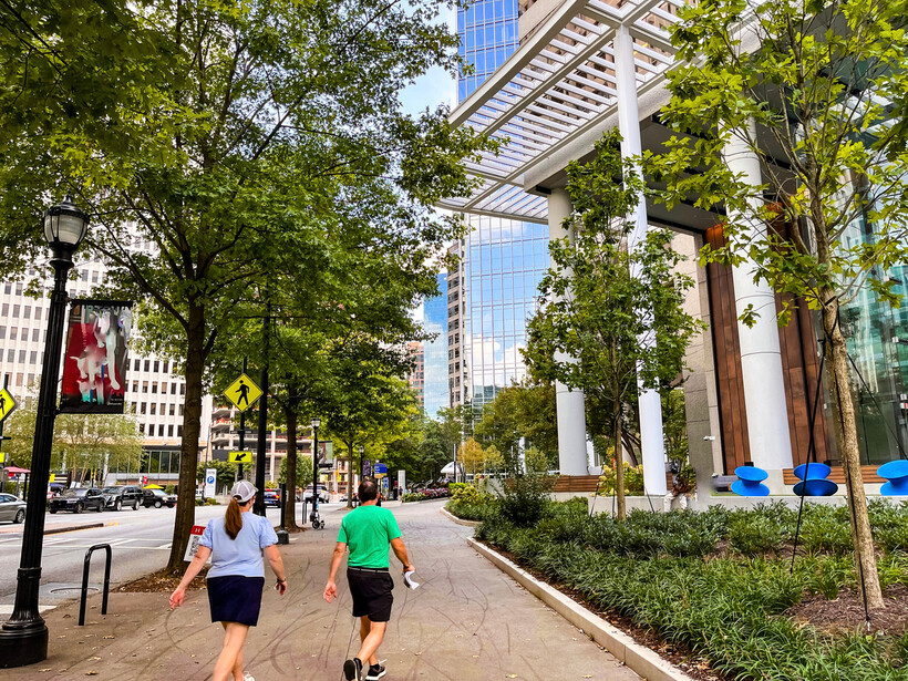Lush green trees lining the streets of a busy Midtown Atlanta neighborhood. - moving to Atlanta