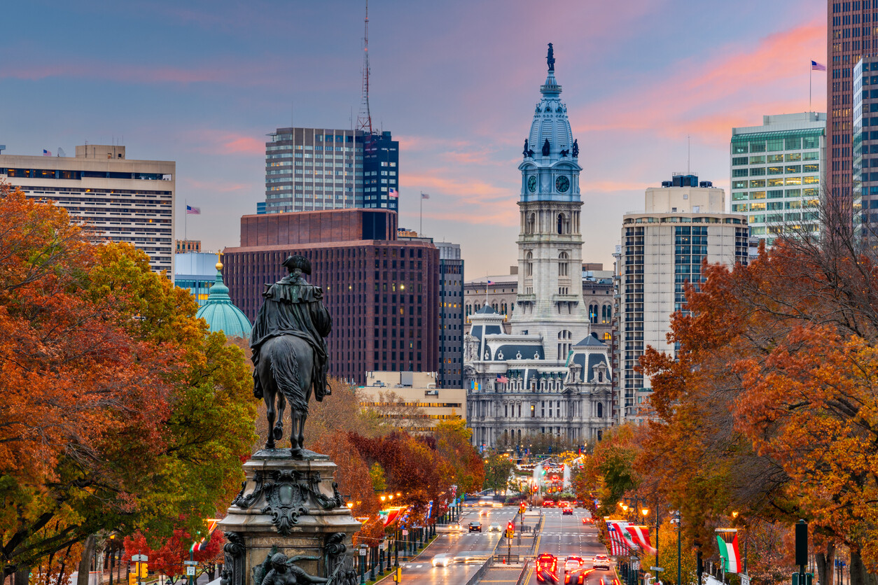 Philadelphia city skyline with William Penn statue and autumn trees in Pennsylvania