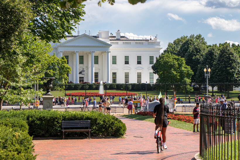The historic exterior of the White House surrounded by lush summer greenery. - moving to Washington DC
