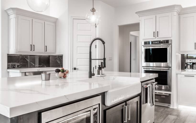 Contemporary kitchen with white cabinetry and island in Sherwin Williams Pure White or Extra White