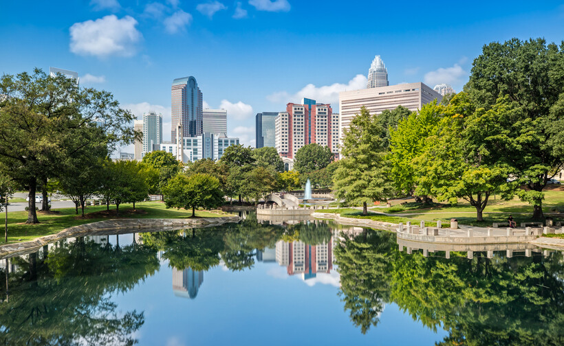 View of skyscrapers from the green space and waterfront at Marshall Park. - moving to Charlotte NC