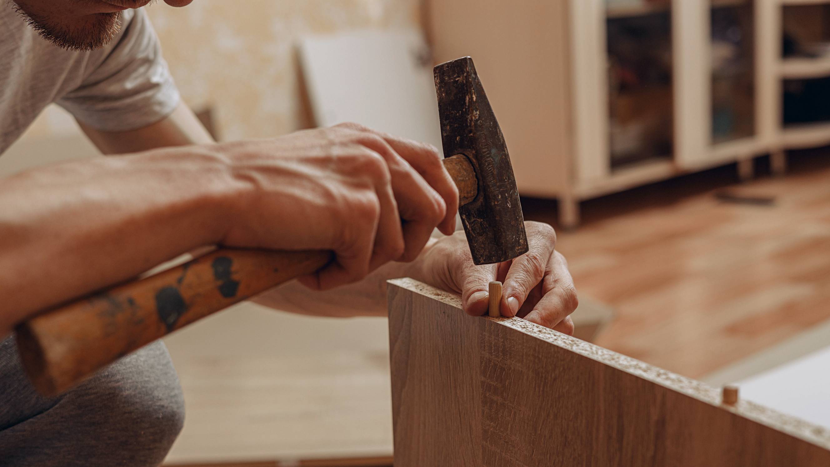 A man engaged in IKEA furniture assembly
