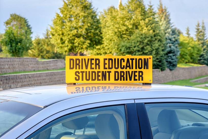 how much do driving lessons cost - Driver education student driver sign mounted on a training car